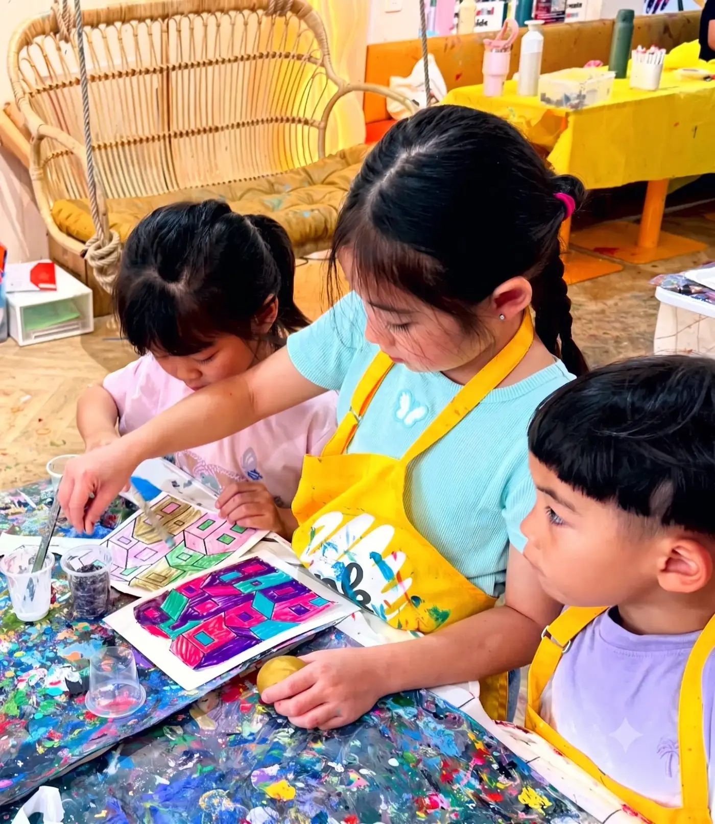 Children colouring geometric artwork at an art camp near Thao Dien