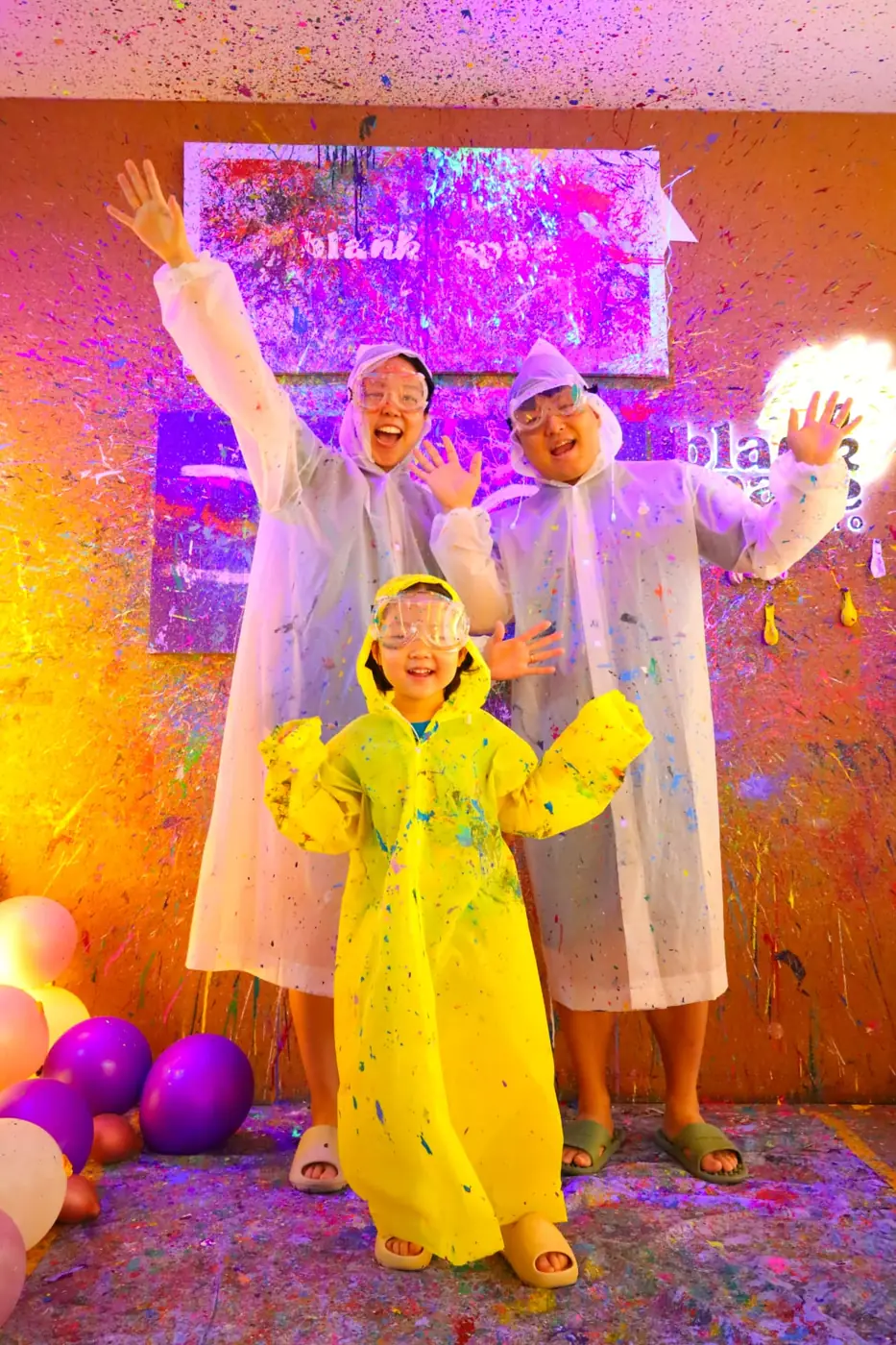 Parent and child celebrating in the splatter room near Thao Dien