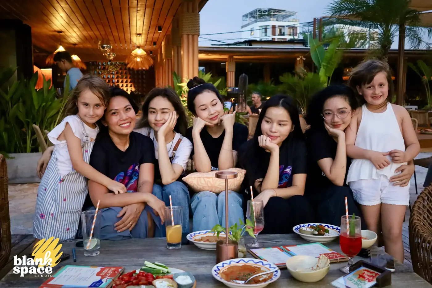 Blank Space Studio team and kids gathered at dinner after the charity auction