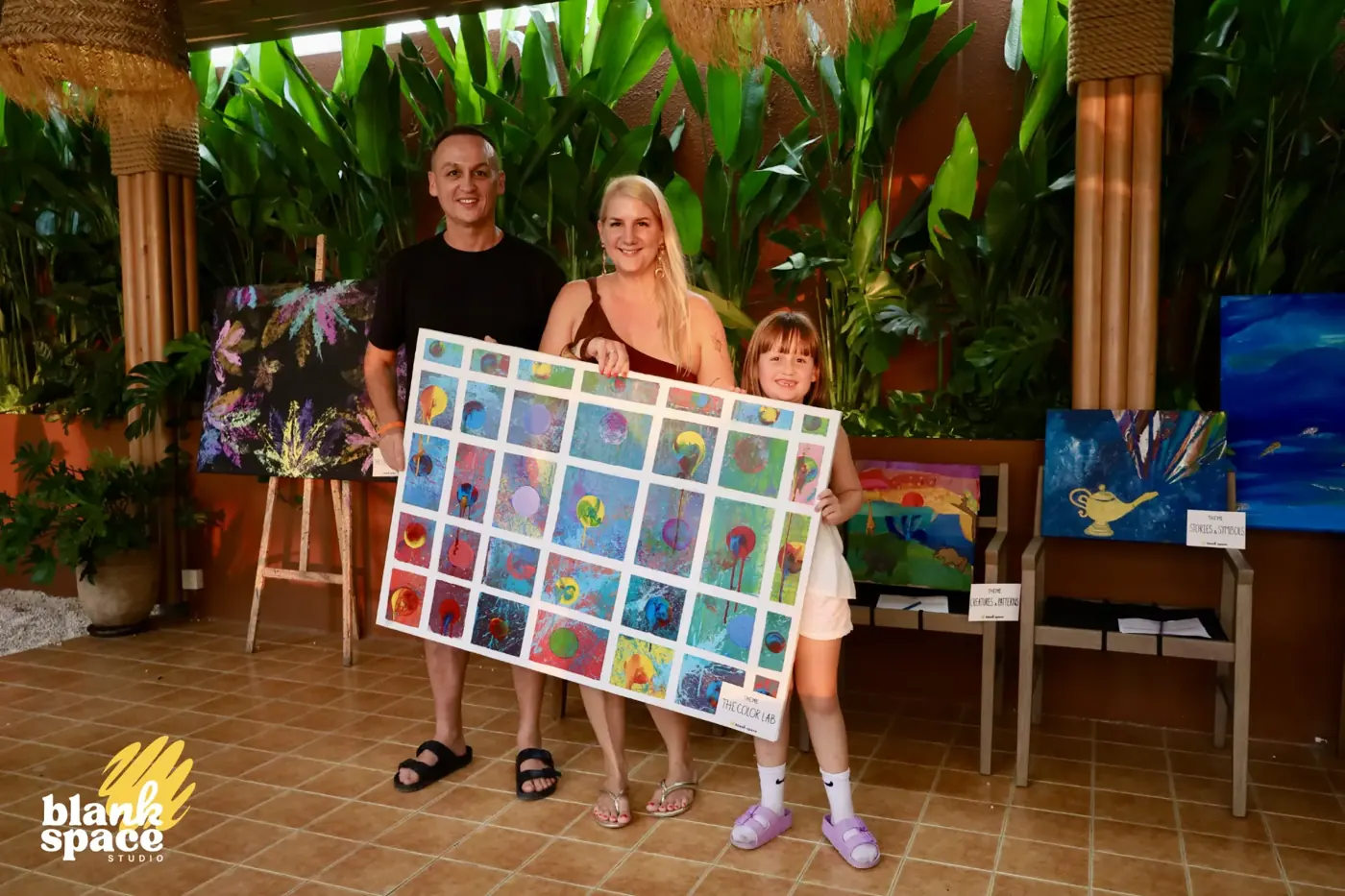 Family showing a large grid collaborative canvas at the charity art auction