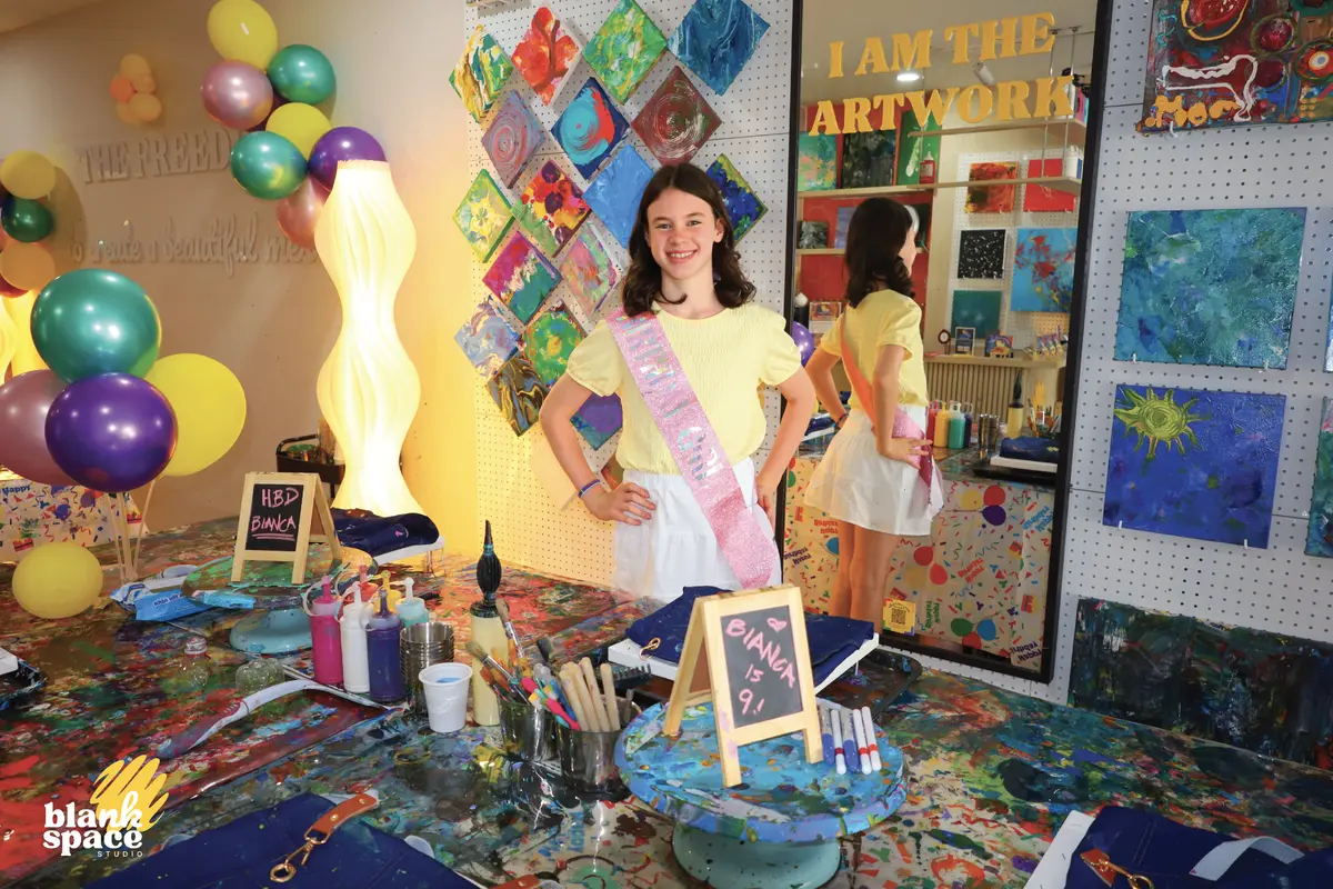 Birthday girl wearing a sash at a kids paint party in Saigon
