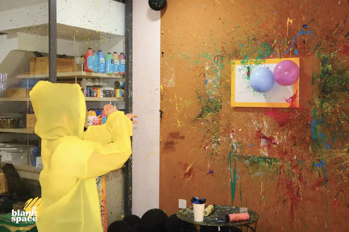 Kid enjoying splatter paint at a birthday celebration in Ho Chi Minh City