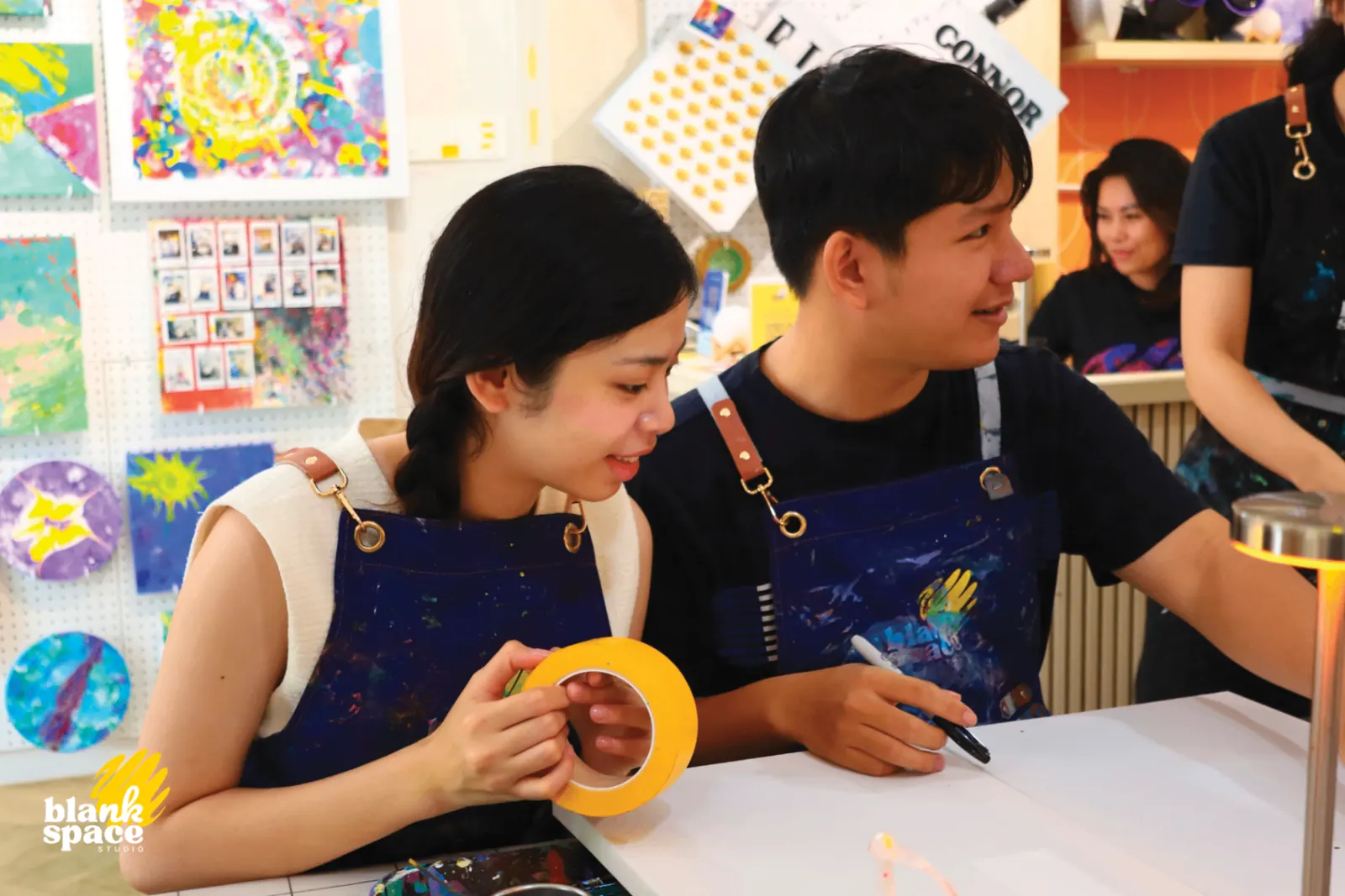 Couple taking part in a team bonding art session at Blank Space Studio
