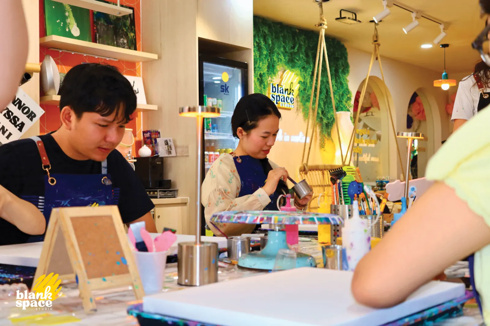 Guests pouring paint during a team bonding session in Saigon