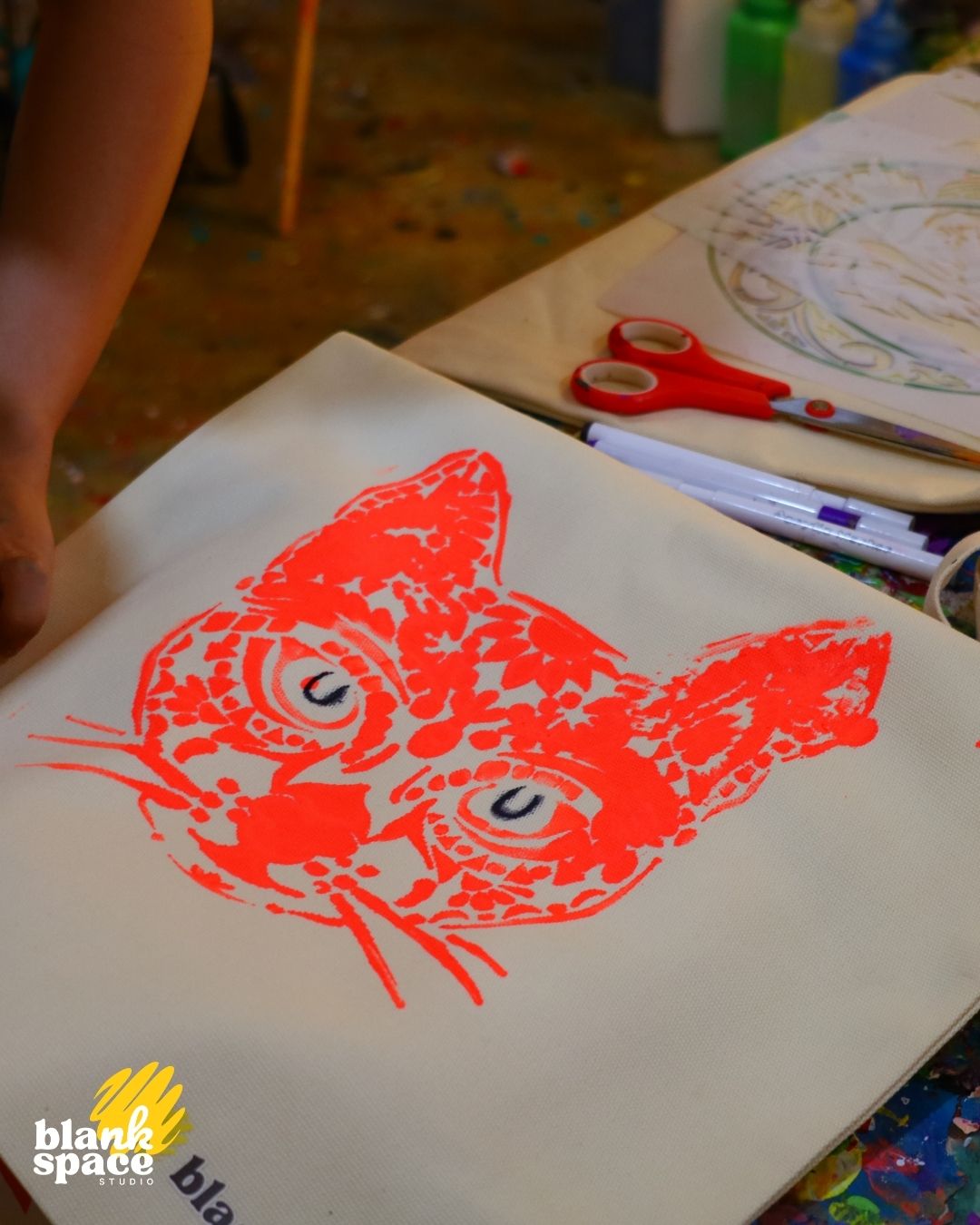 Stencil cat print on tote bag at a creative kids birthday party in Saigon