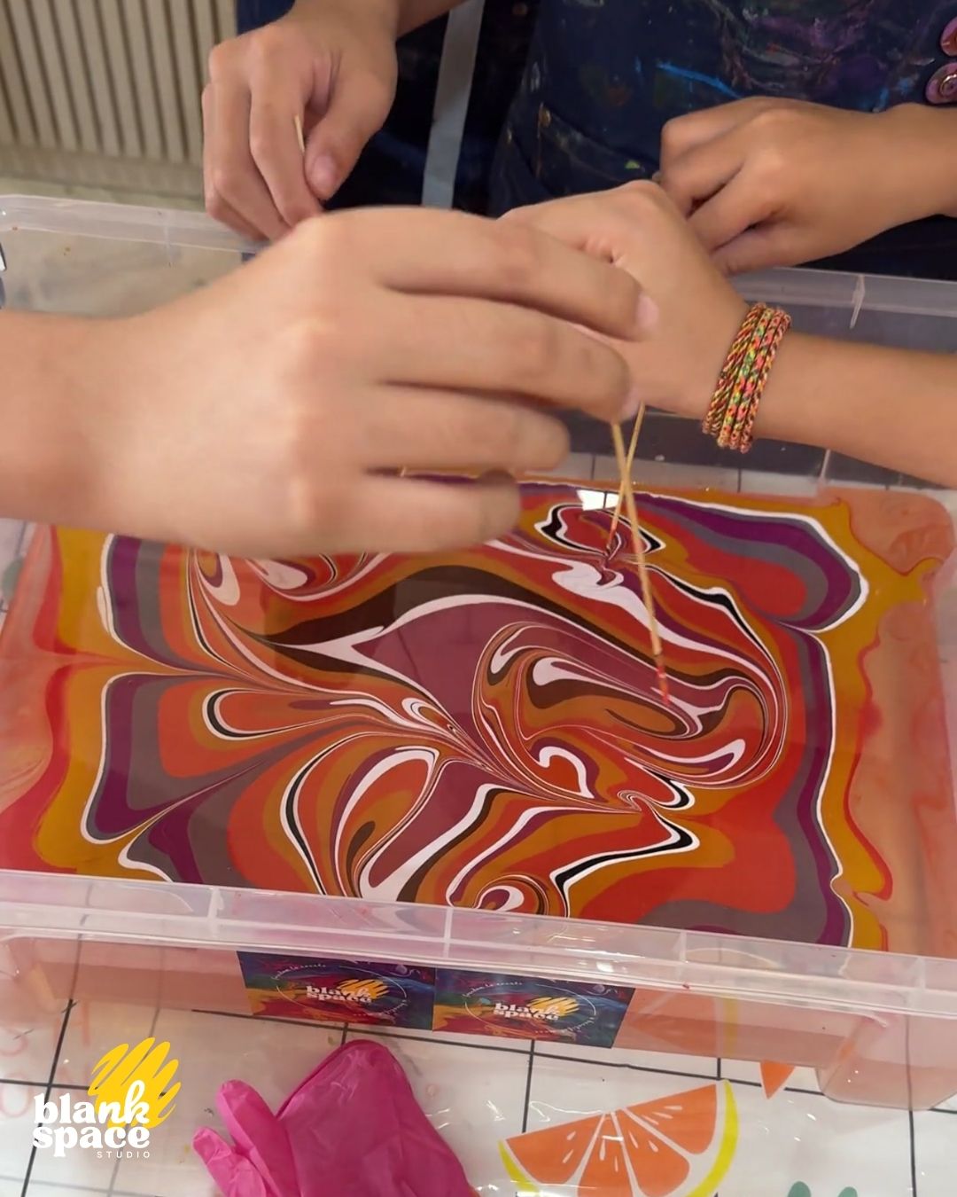 Kids doing water-marbling art at a birthday experience in Ho Chi Minh City