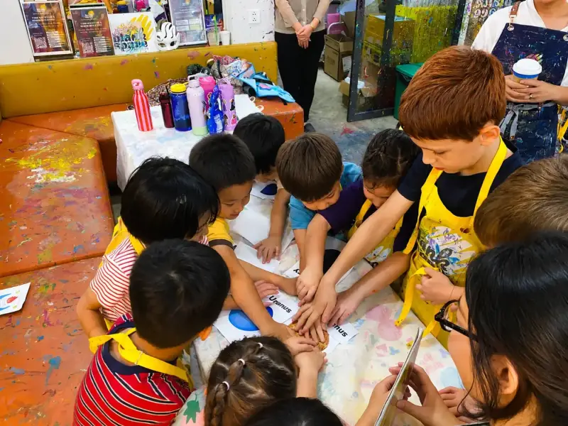 Camp friends working together on a creative project in Ho Chi Minh City
