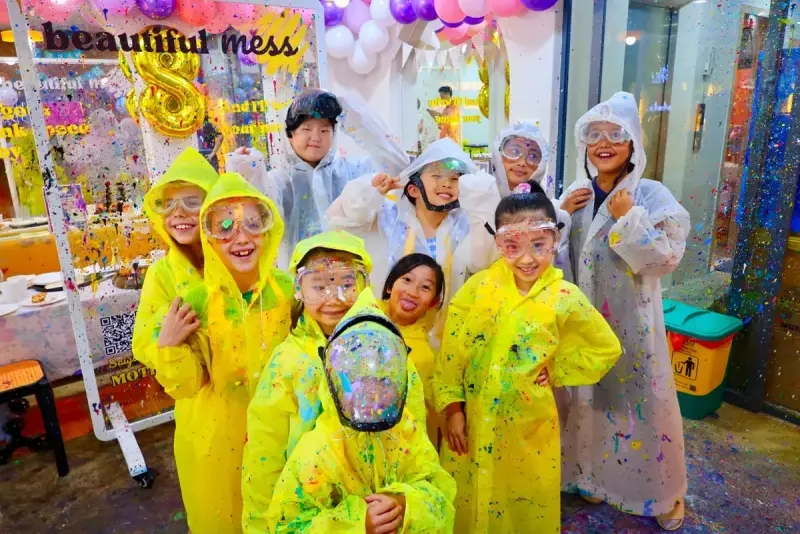 Group of kids in splatter ponchos and goggles at a birthday party in Ho Chi Minh City