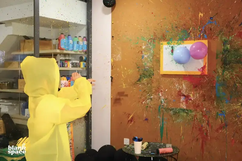 Kid enjoying splatter paint at a birthday celebration in Ho Chi Minh City