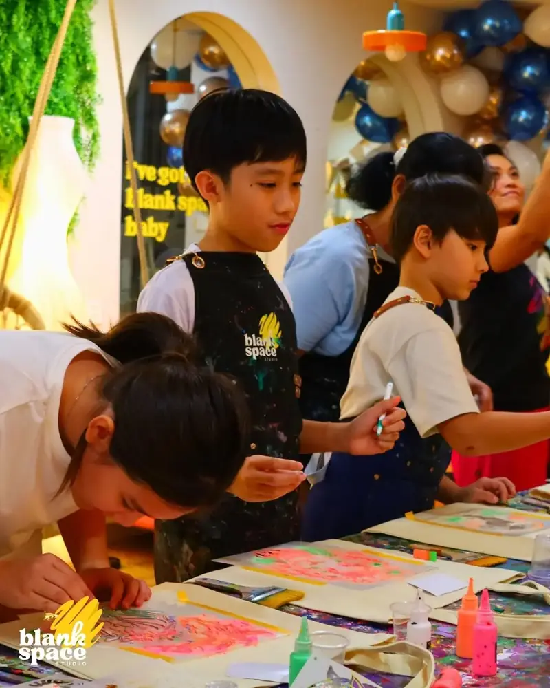Kids in aprons painting at a birthday celebration at Blank Space Studio Ho Chi Minh City