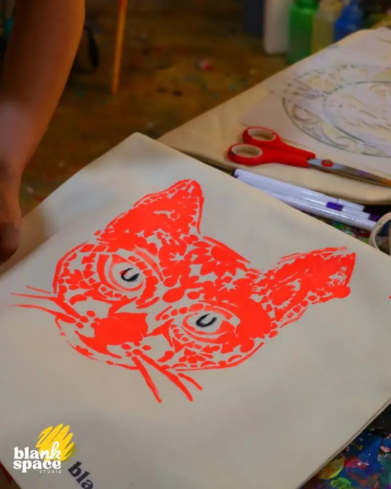 Stencil cat print on tote bag at a creative kids birthday party in Saigon