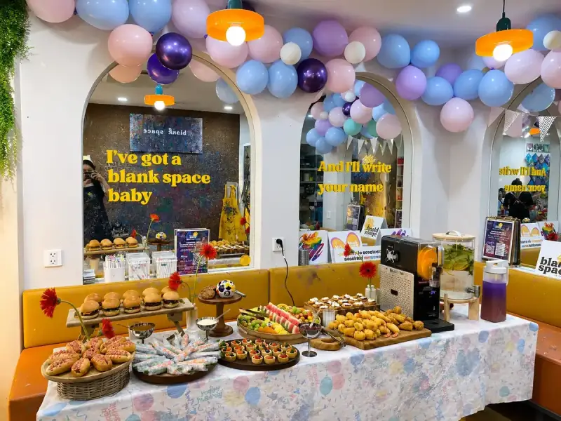 Birthday party food table and balloon decor at Blank Space Studio Saigon