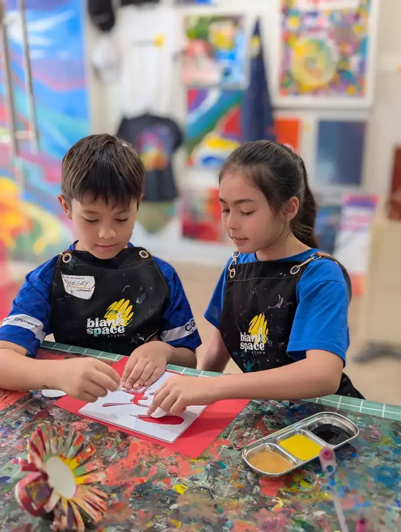 Kids doing paper craft at a school holiday camp in Ho Chi Minh City