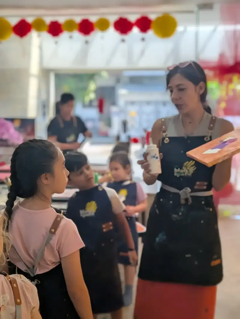 Staff guiding kids at a holiday art camp in Ho Chi Minh City