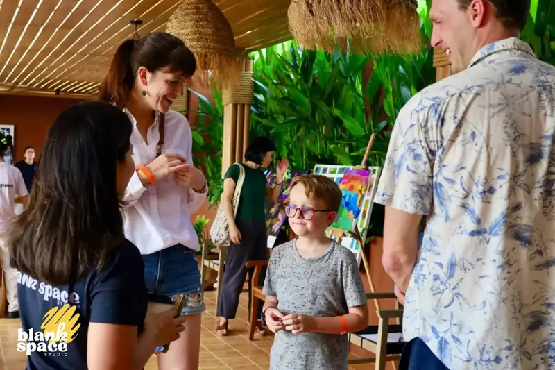 Families chatting at the Blank Space Studio charity art auction in Saigon