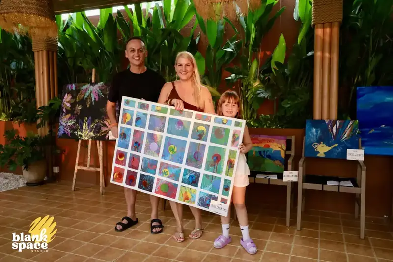 Family showing a large grid collaborative canvas at the charity art auction