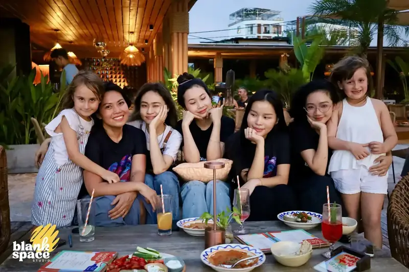 Blank Space Studio team and kids gathered at dinner after the charity auction