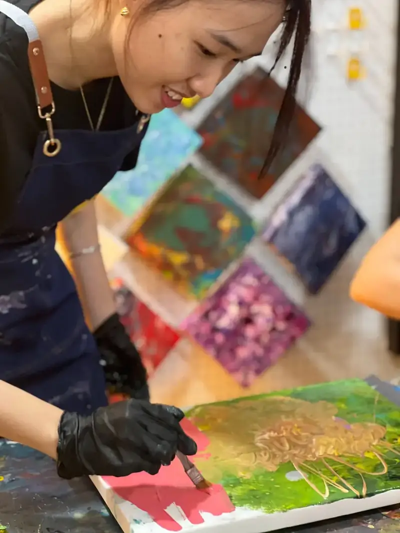Team member painting canvas at a corporate team building event in Ho Chi Minh City