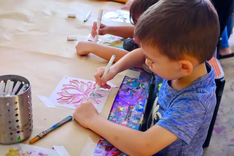 Kids making their own hand-painted cards at a creative celebration in Saigon