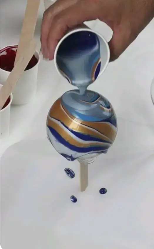 Handmade paint-poured ornaments crafted at a holiday workshop in Saigon