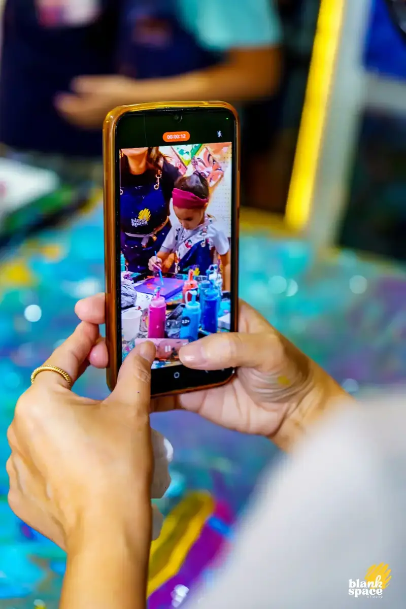 Parent recording kids enjoying indoor art activities in Ho Chi Minh City