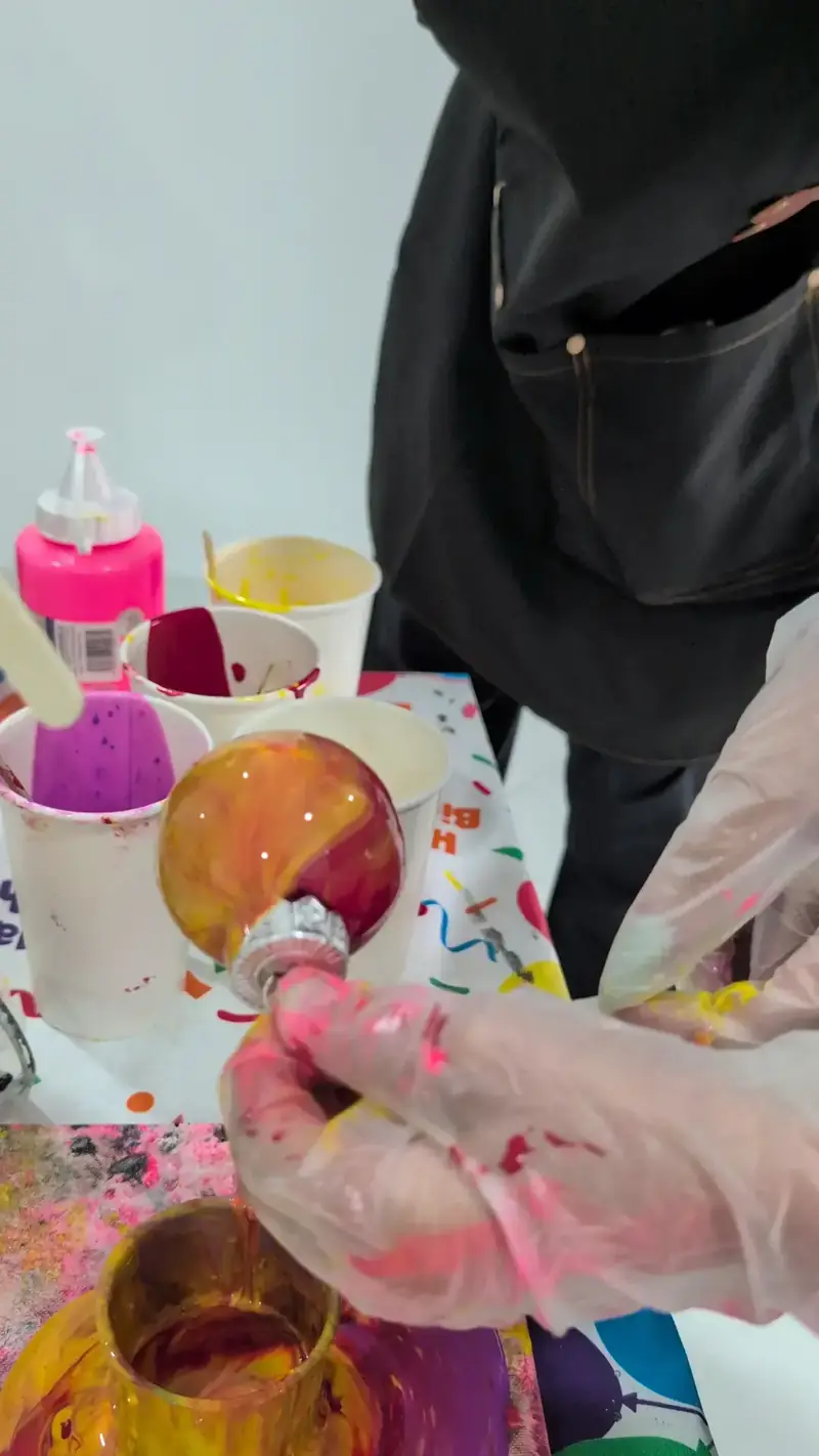 Motion-art paint swirling on canvas at a creative workshop near Thao Dien