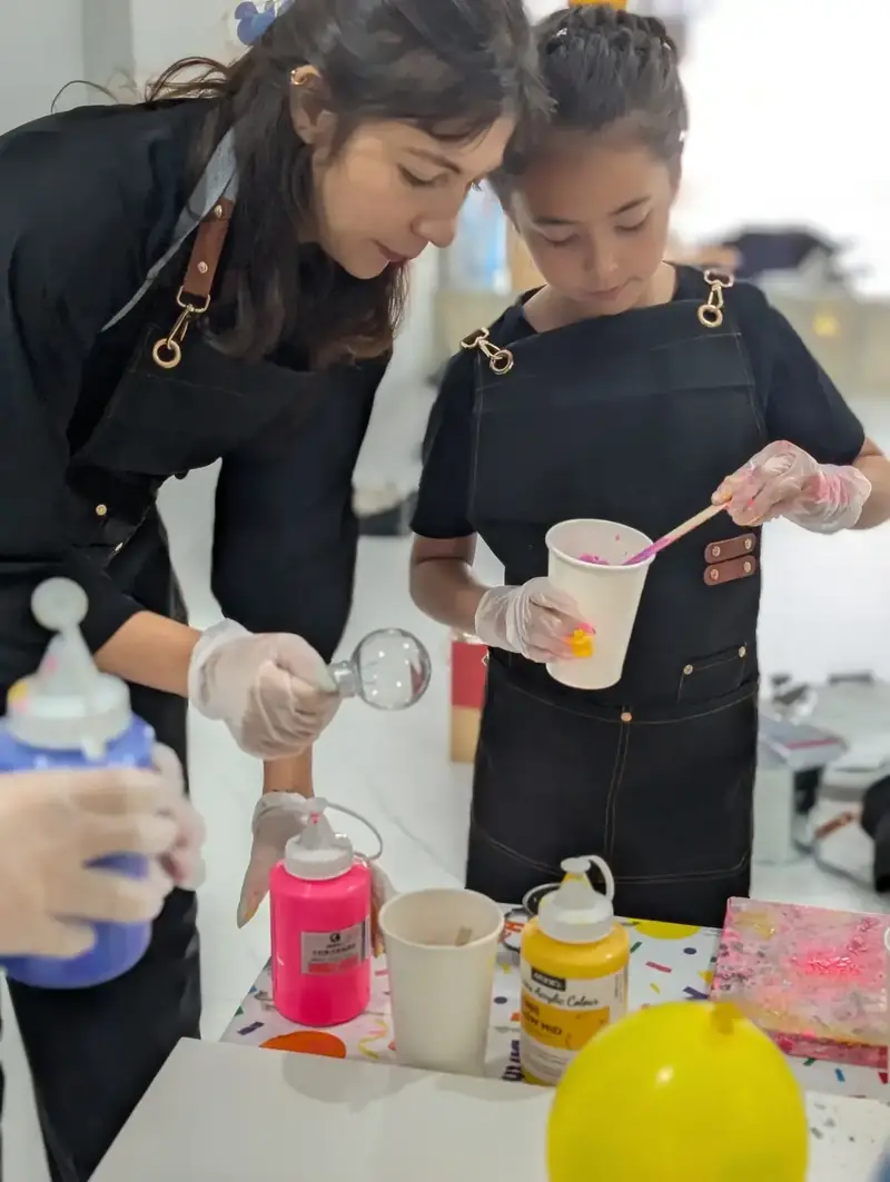 Acrylic pouring and color blending at a school group activity in Saigon