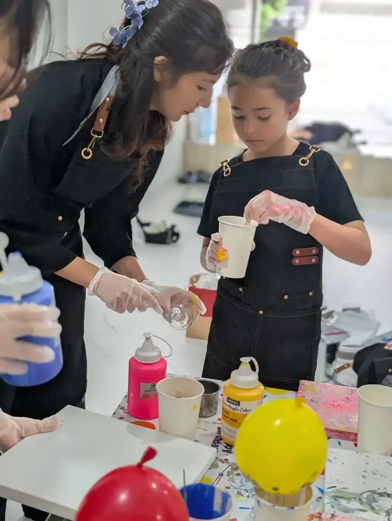 Paint pouring setup with vibrant colors at Blank Space Studio HCMC