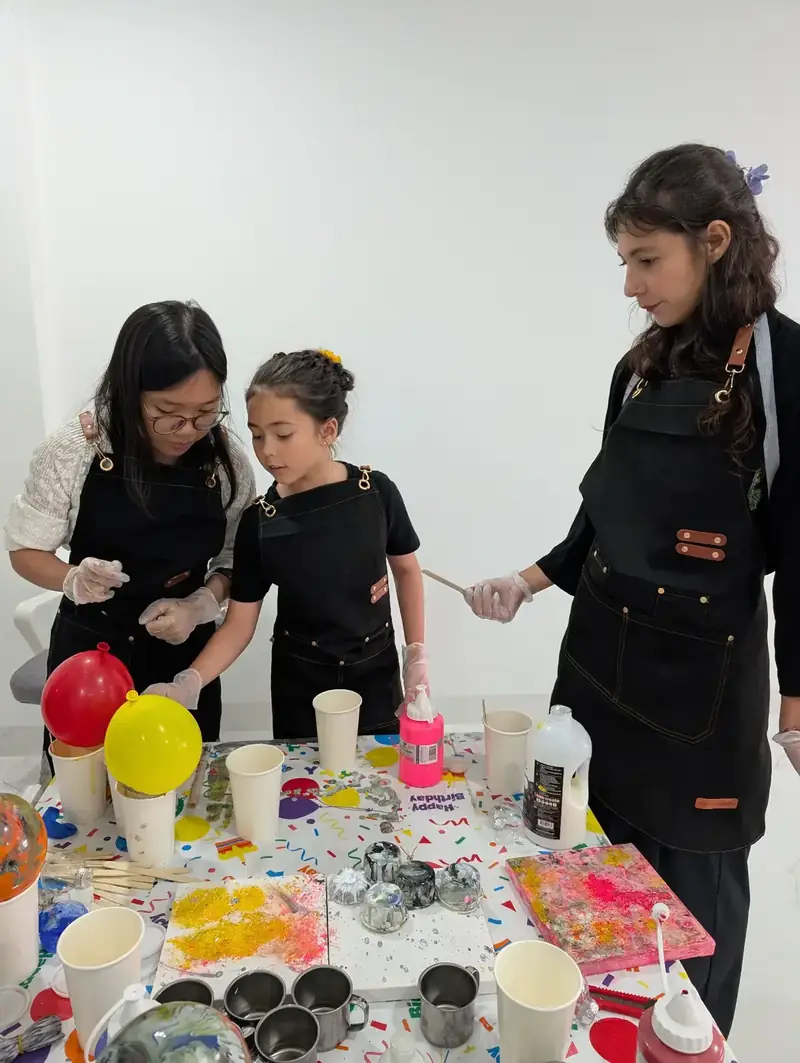 Guest designing abstract paint pour canvas at a team bonding session in Saigon