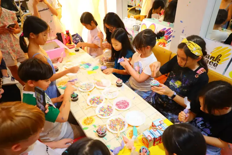 Kids decorating cupcakes together at a private studio event in Ho Chi Minh City