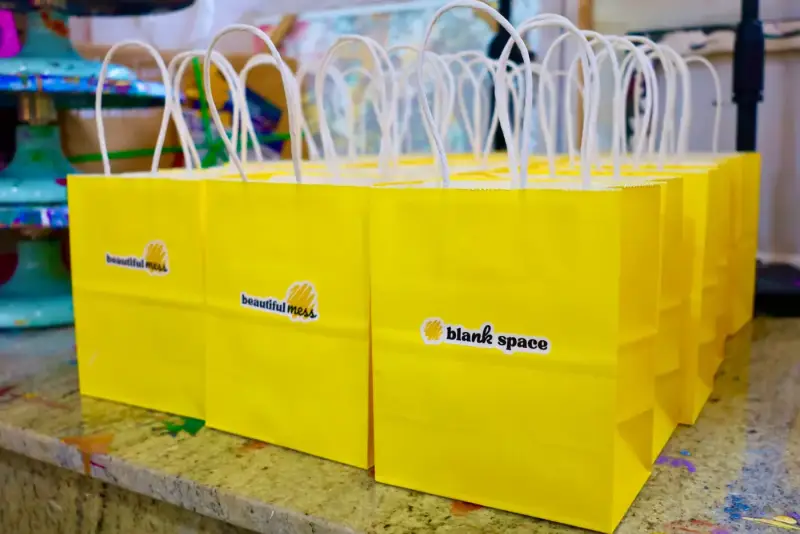Yellow Blank Space goodie bags prepared for guests at a private studio party