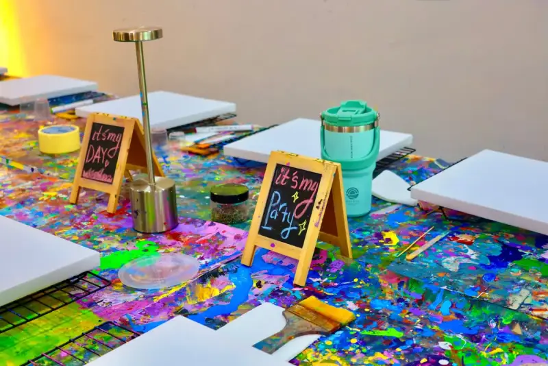 Private studio table set with canvases and it is my party signs in Ho Chi Minh City