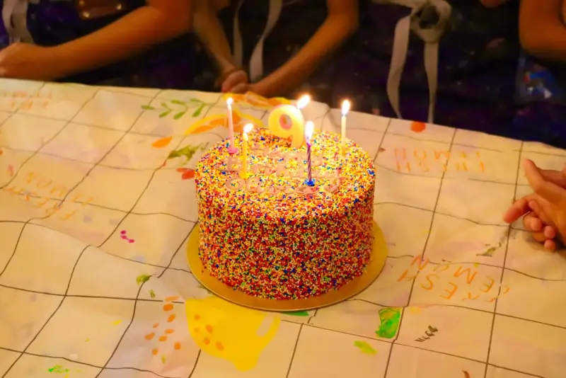 Guests bringing their own birthday cake to a private studio event at Blank Space Studio