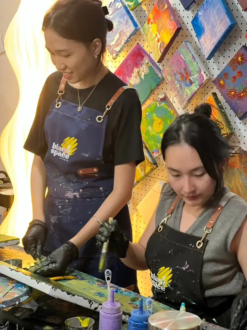 Corporate team in aprons creating artwork at Blank Space Studio