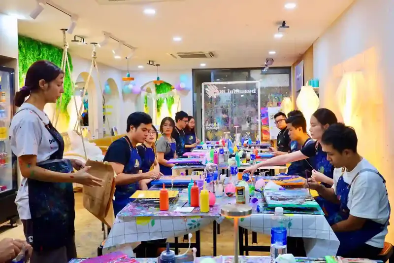 Team bonding group pouring paint with no art skills needed at Blank Space Studio Saigon