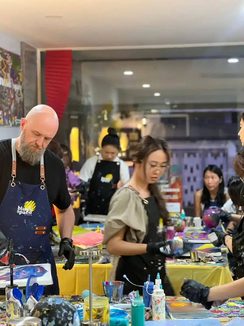 Team collaborating on paint art at a team building venue in Saigon