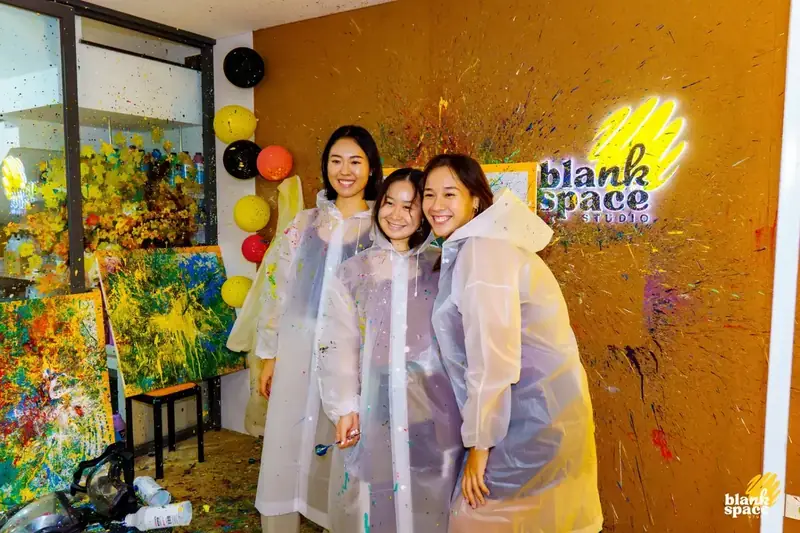 Group posing with finished artwork at a team building event in Ho Chi Minh City